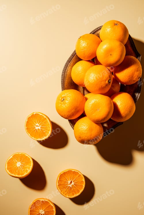Preview: Flat lay with tangerines in metal bowl on beige backdrop