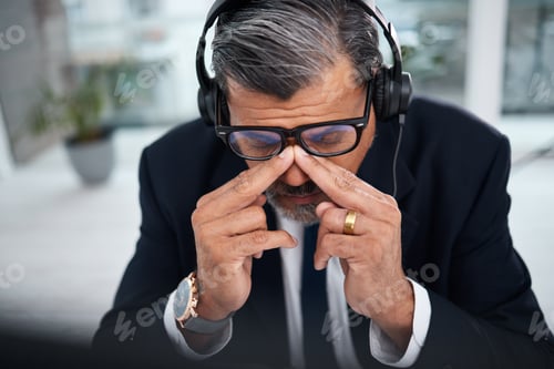 Preview: Depressed, tired and man in a call center with a headache from telemarketing or technical support.