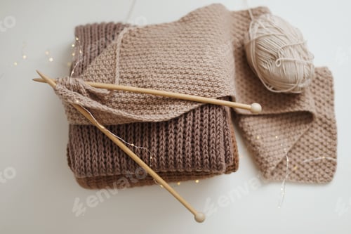 Preview: Knitted Scarves and Yarn with Knitting Needles