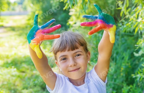 Preview: child with painted hands and legs. Selective focus.