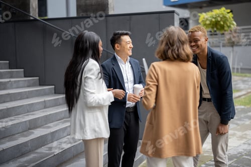 Preview: Multiracial business team talking on city street