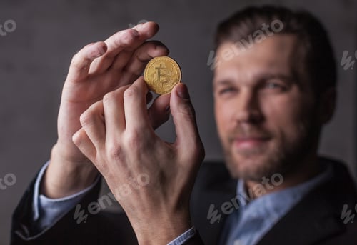 Preview: Man holds bitcoin in hands