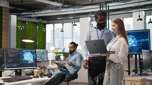 Preview: Junior dev and colleague in office reviewing AI system metrics