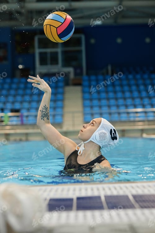 Preview: Young active female water polo player throwing ball over herself