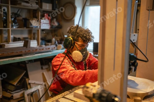 Preview: Carpentry workshop craftsman master working. Manual wood milling guy holds tool controlling process