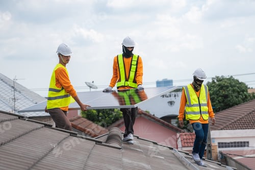 Preview: Service engineer installing solar cell on the roof of house. Technicians working about solar panel.