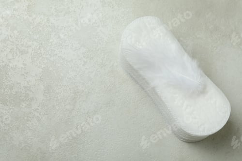 Preview: Stack of sanitary pads on white textured background