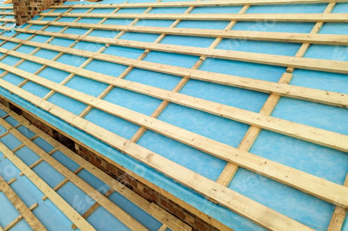 Preview: Aerial view of a brick house with wooden roof frame under construction