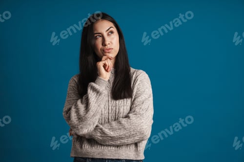 Preview: Puzzled beautiful asian girl thinking and looking aside