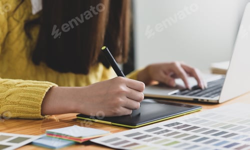 Preview: female designer sketching on a digital graphic tablet.
