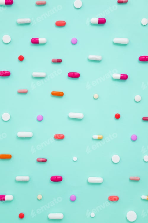 Preview: Various white medication tablets and capsules on green background. Concept of healthcare medicine