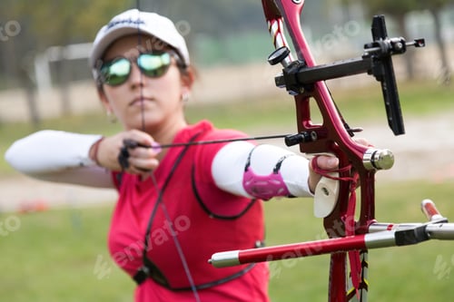 Preview: Female athlete practicing archery in stadium