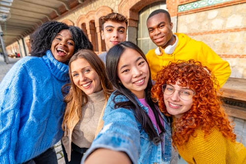 Preview: Chinese girl and diverse friends taking a selfie outdoors
