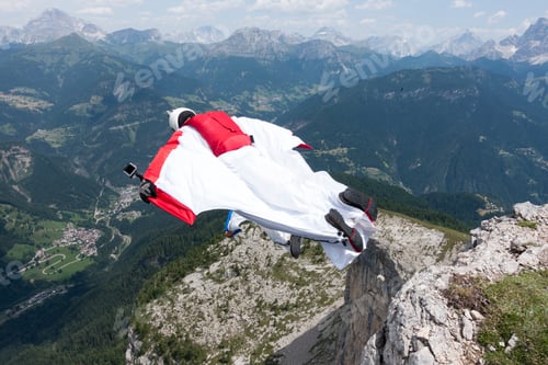 Preview: Two male BASE jumpers exiting from mountain top, Dolomites, Italy