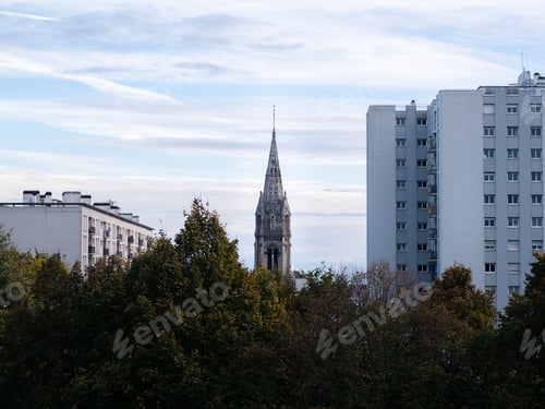 Preview: Majestic church tower standing tall between buildings in Paris, France