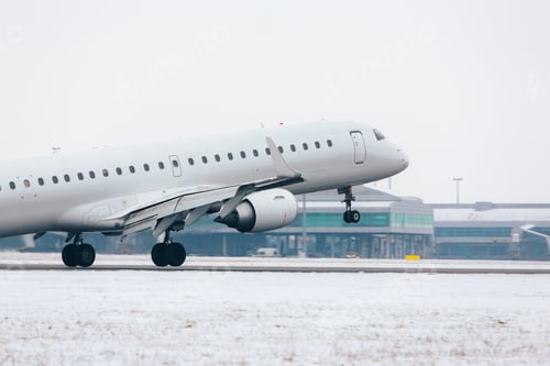Preview: Airplane landing on airport runway during winter day.
