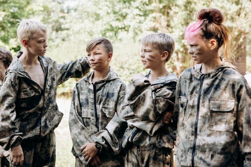 Preview: Group of teenager boy and girl in military uniform standing and waiting laser tag shooting game
