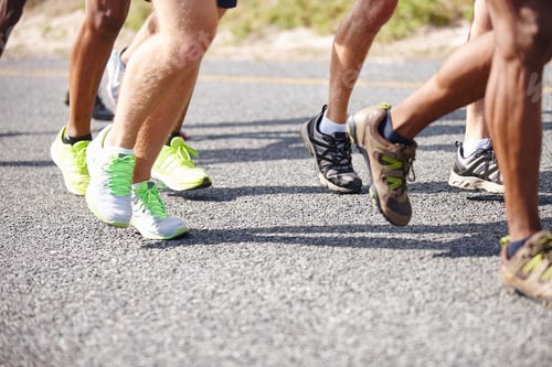 Preview: Who will be the winner. Shot of the legs of a group of men running a road race.