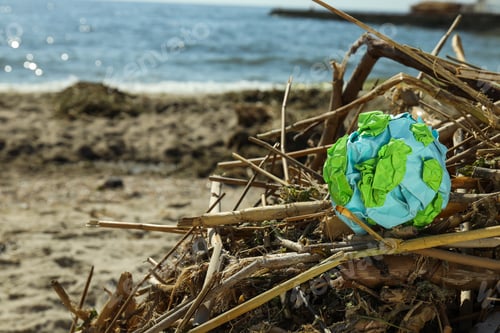 Preview: A paper model of the Earth is crumpled on the garbage