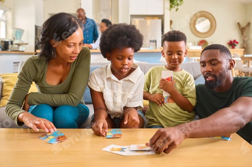 Preview: Family Indoors At Home With Playing Cards With Grandparents In Background