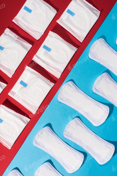 Preview: top view of rows of pads and daily liners on red and blue
