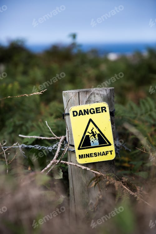 Preview: A yellow warning sign showing the danger of falling down a hidden mineshaft