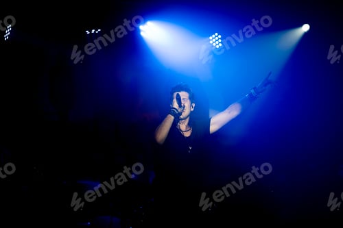 Preview: Young energetic singer performing in a club under blue led lights