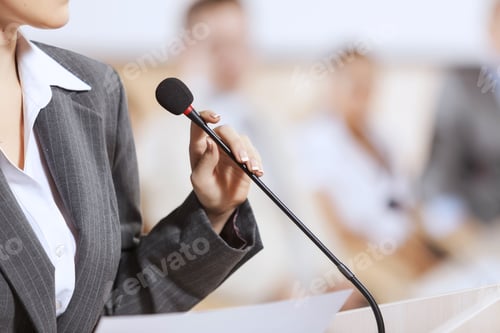 Preview: Businesswoman Standing On Stage And Reporting For Audience