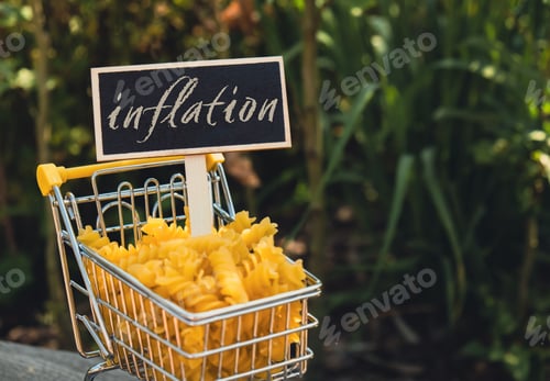 Preview: INFLATION text on Blackboard label Shopping trolley cart Filled With Pasta on agriculture background