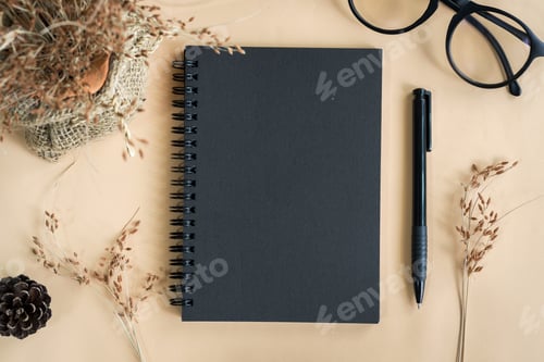 Preview: Dry flower with blank notebook in workspace