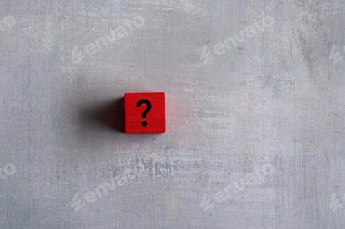 Preview: Red cubes with question mark on concrete background. Copy space for text.