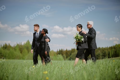 Preview: Group of Middle Aged Caucasian and Black Adults Walking Together at Funeral