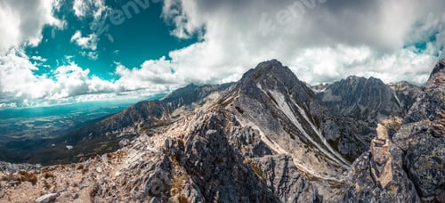 Preview: Mountain stone range peak against blue cloudy sky