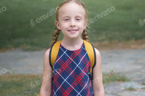 Preview: blonde schoolgirl with a yellow backpack, radiating joy on her way to school, Back to school concept