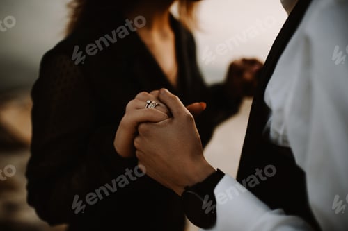 Preview: Loving couple with hold hands on the seashore at sunset