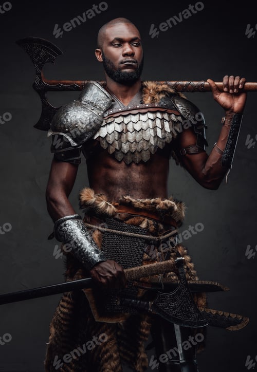Preview: Authentic military man with two axes posing in dark background