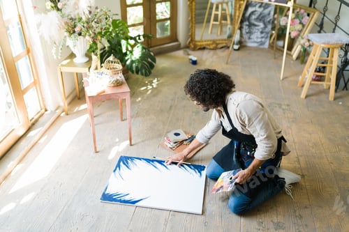 Preview: Young man painting at a workshop