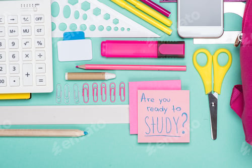 Preview: flat lay with various school supplies on colorful surface