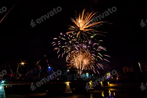 Preview: Colorful fireworks display and celebration for New year eve over iron bridge in Chiang Mai, Thailand