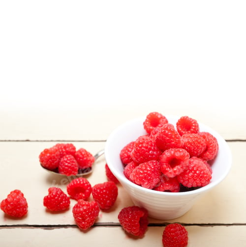 Preview: bunch of fresh raspberry on a bowl and white table