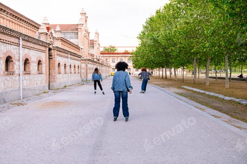 Preview: Friends skating together in urban park during sunny afternoon