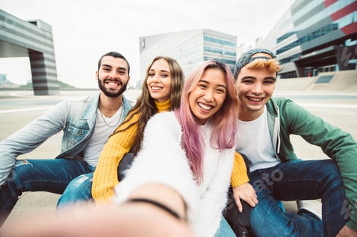 Preview: Multiracial group of friends taking selfie in a urban street