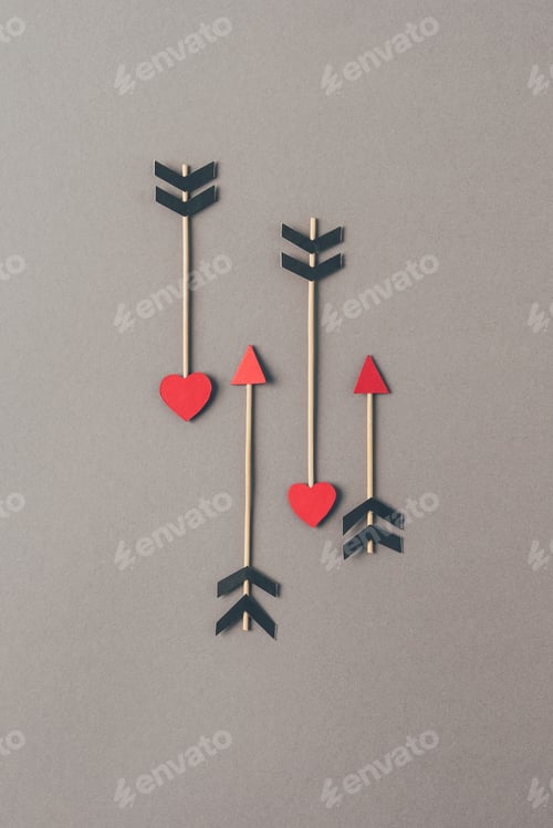 Preview: top view of four arrows on gray surface, valentines day concept