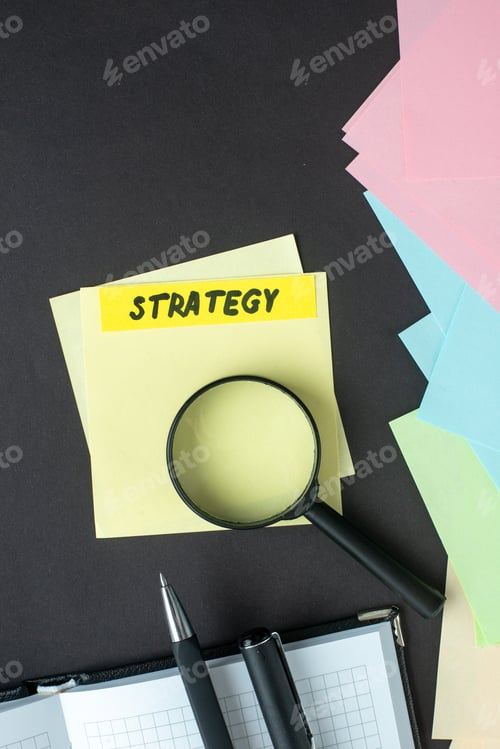 Preview: top view strategy note with stickers pens and magnifier on dark background strategy leadership