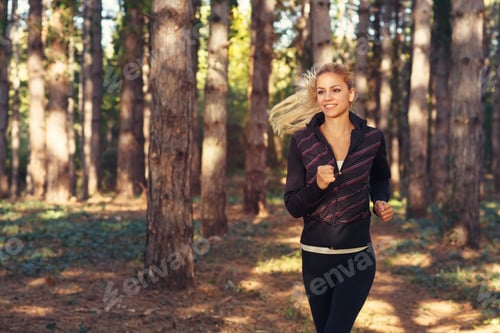Preview: Beautiful young woman running through the park