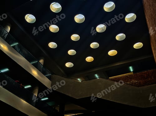 Preview: some round lights are on the ceiling over a building area