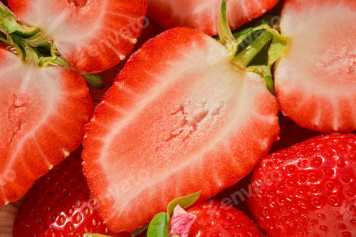 Preview: Half of a strawberry close-up on a wooden table