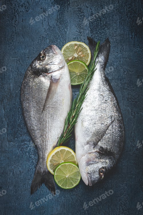 Preview: fresh, raw dorado fish, on a dark blue background, top view, two pieces, no people,