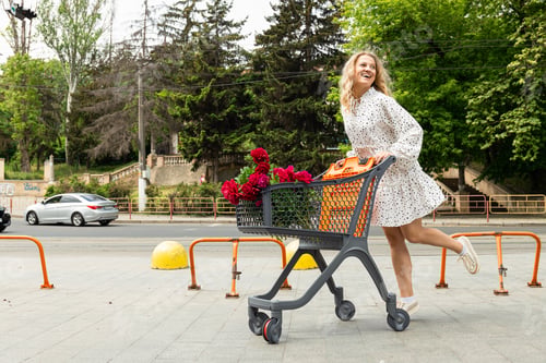 Preview: A beautiful girl with a cart with flowers on the street.
