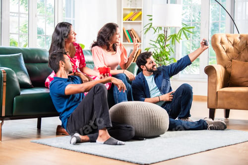 Preview: Indian asian young couple taking selfie using smartphone at home